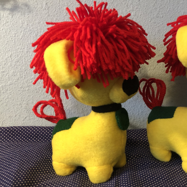 A yellow dog plush with red yarn hair. Picture links to project page.
