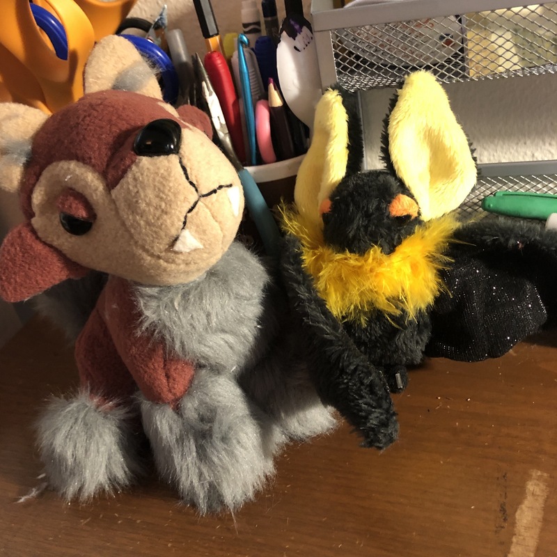 A brown and grey sitting dog plush and a black and yellow bat plush. Picture links to project page.