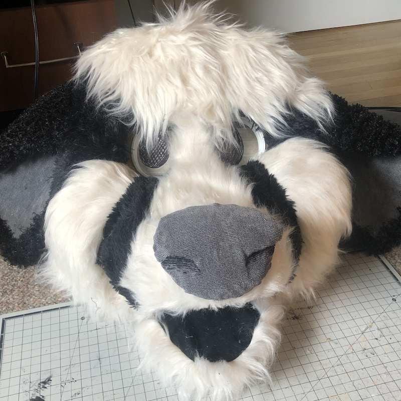 A large and cartoony black and white cow head puppet. The mouth is open and smiling. Picture links to project page.