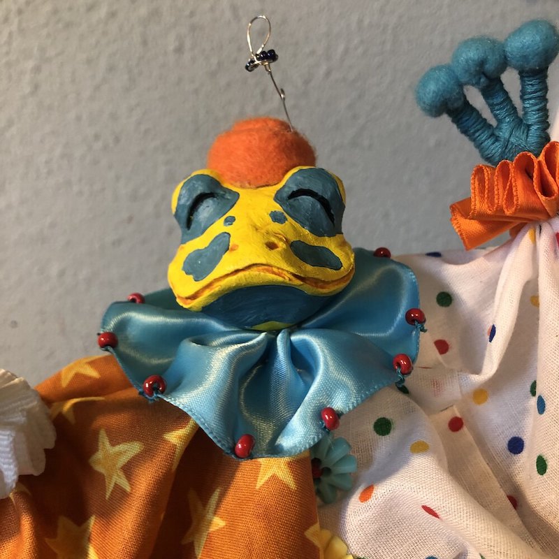 A yellow and blue poison dart frog dressed in a baggy clown costume. Picture links to project page.