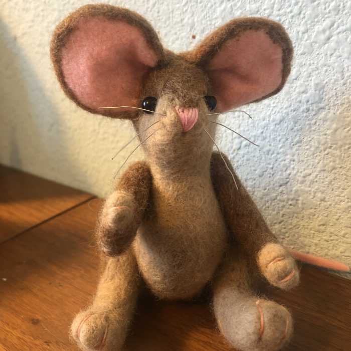 A wool felted mouse, brown with pink ears and nose and beady black glass eyes. Link takes you to project page.
