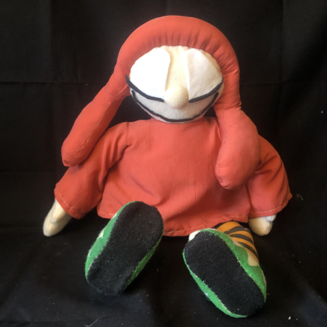 A rag doll with closed eyes, wearing an orange robe and hat with long droopy ears. Link takes you to project page.