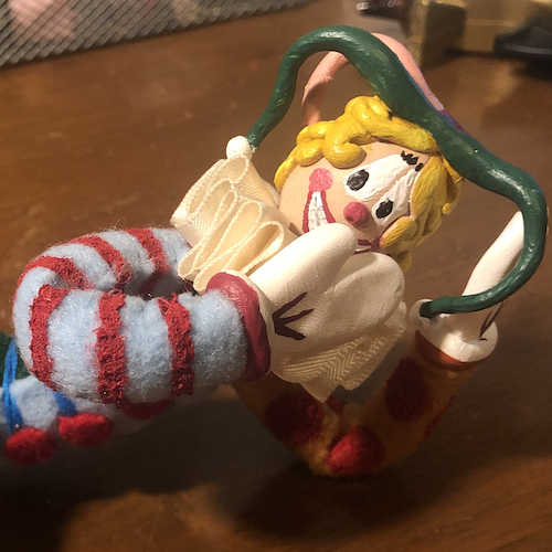 Close up of a clown doll with felt body, clay face, and long, noodley felt limbs. Link takes you to project page.