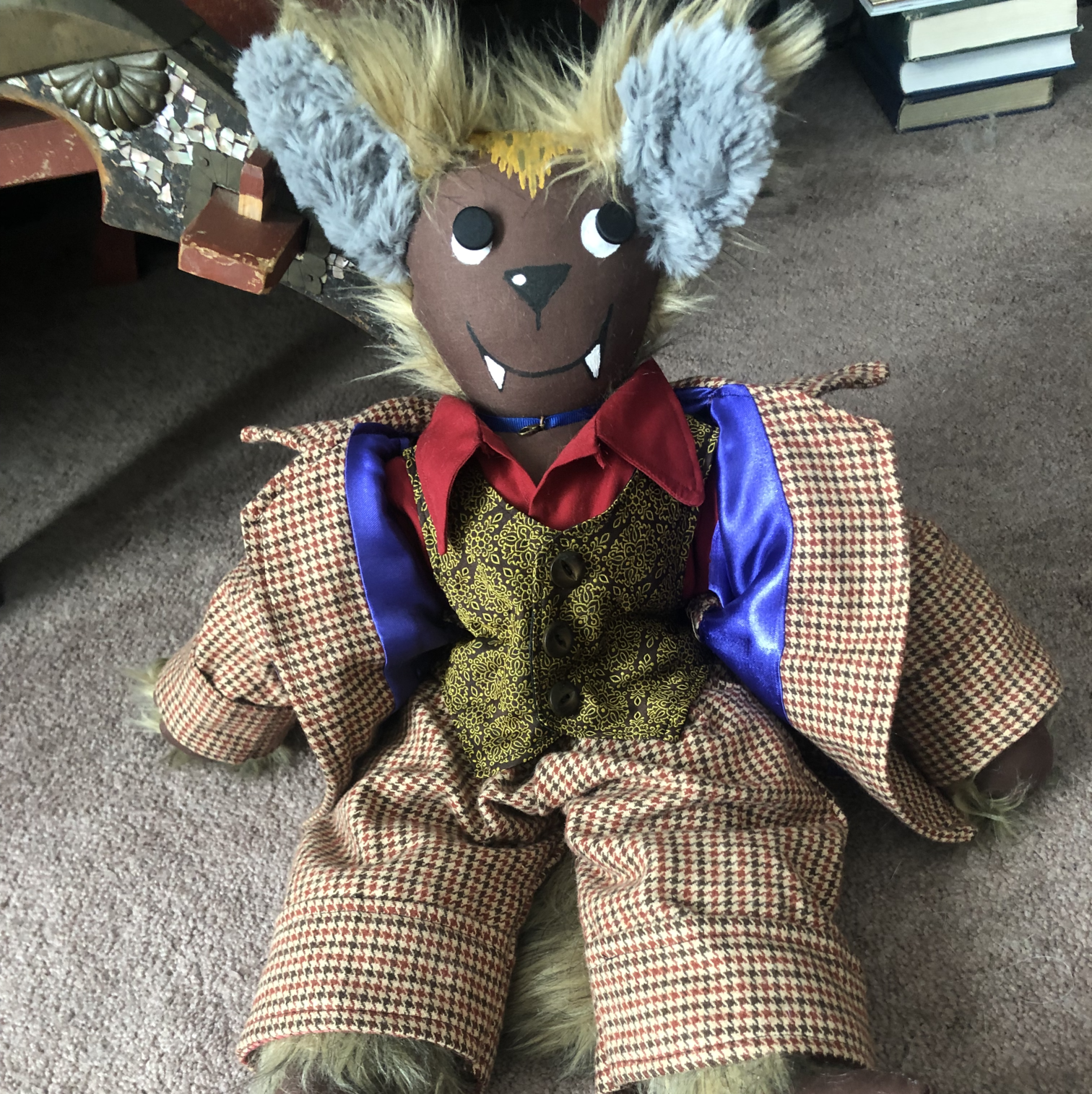 A rag doll of a fluffy wolf-man character in a brown suit and gold vest. Link takes you to project page.